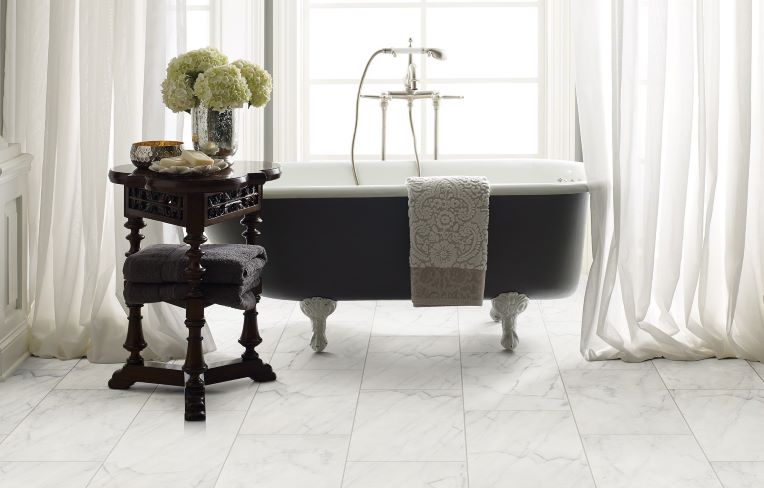 bathroom remodeling example with a beautiful white marble floor and freestanding porcelain tub